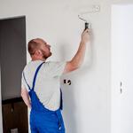 Professional Painter Painting A Wall White