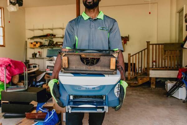 Local Junkluggers help declutter a garage.