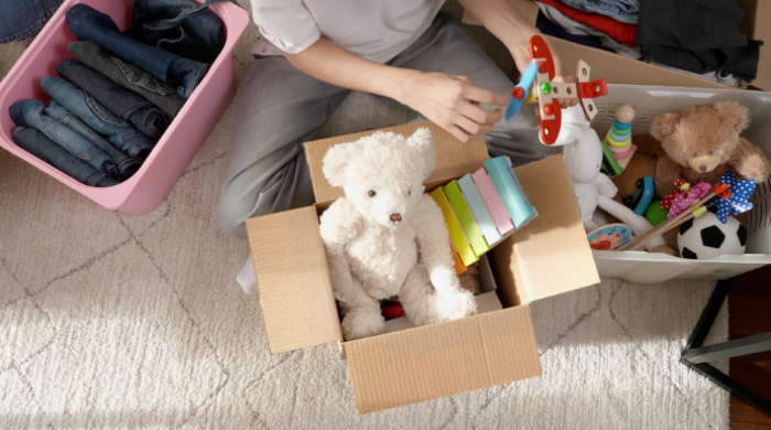 person boxing up toys